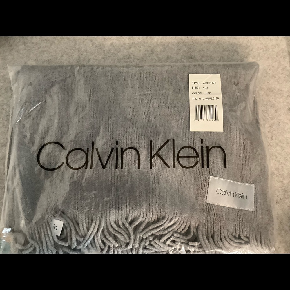 Calvin Klein very soft gray knit scarf with fringe.